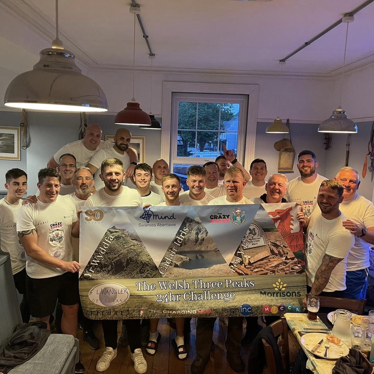 17 Men Holding Banner After Raising Money For Mind Swansea